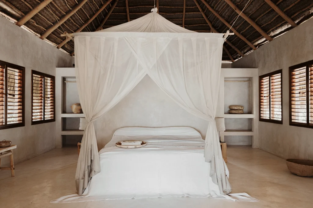 Sussurro lodge main bedroom with high ceilings and draped mosquito net.
