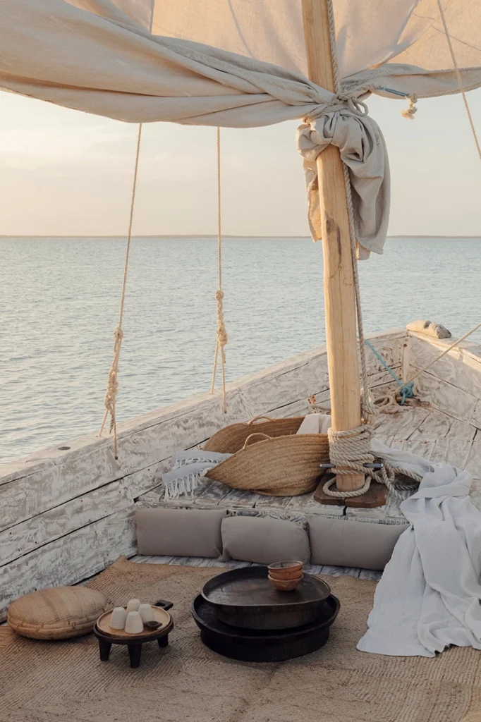 Detail of a lounging set up on a dhow that is sailing on the ocean.