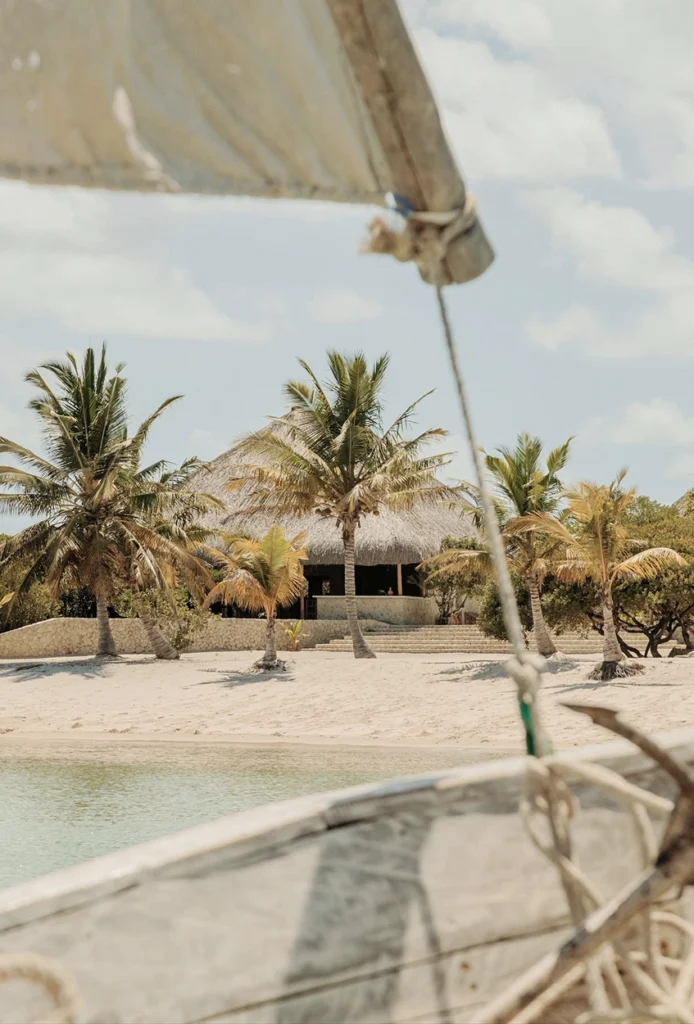 View of beach lodge in Mozabique from a traditional Dhow.