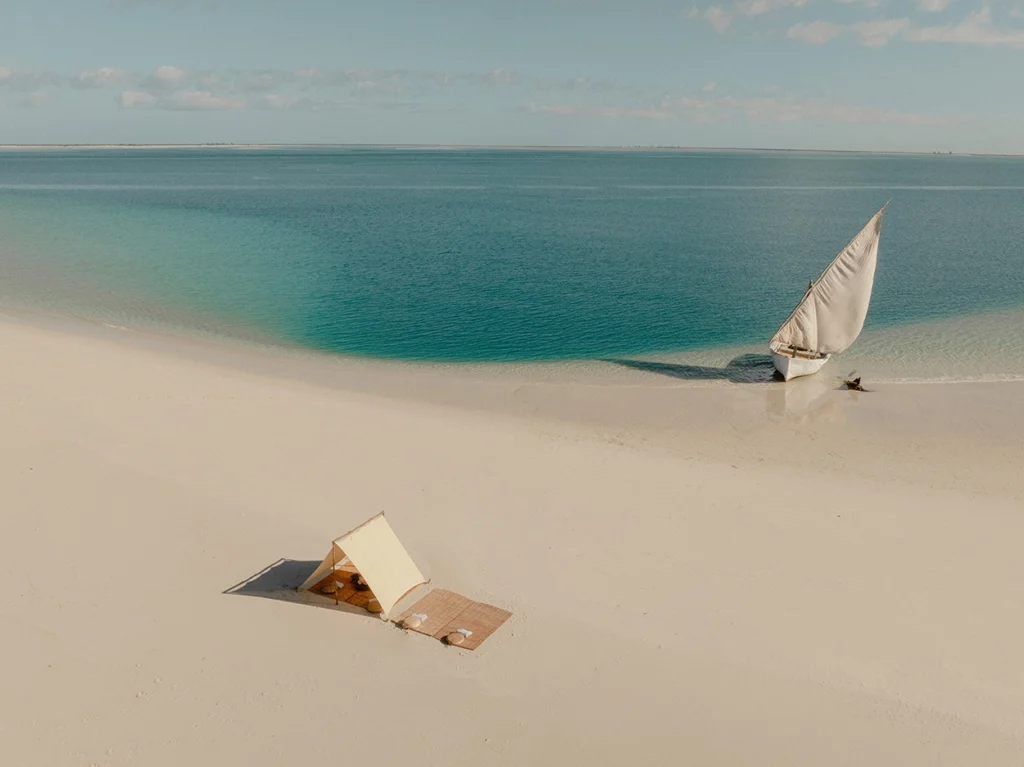 View of Sussurro beach with dhow and tent.